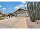 Charming single-story home featuring desert landscaping, a stone facade, and a spacious two-car garage at 14458 W Powderhorn Dr, Surprise, AZ 85374