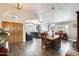 Inviting living and dining area with wood floors, a vaulted ceiling, a large window, and a cozy seating area at 14458 W Powderhorn Dr, Surprise, AZ 85374