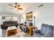 Cozy living room featuring comfortable seating, wood floors, ceiling fan and a sliding door at 14458 W Powderhorn Dr, Surprise, AZ 85374