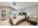 The main bedroom boasts a ceiling fan, neutral tones, and ample natural light, creating a relaxing retreat at 14458 W Powderhorn Dr, Surprise, AZ 85374