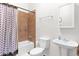 Bright bathroom with terracotta tiled shower-tub combination and a modern pedestal sink at 1454 E Flower St, Phoenix, AZ 85014