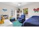 Bright bedroom featuring a blue accent chair, plush bedding, and stylish decorative elements at 1454 E Flower St, Phoenix, AZ 85014