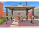 Covered gazebo featuring dining set, curtains, and vibrant bougainvillea at 1454 E Flower St, Phoenix, AZ 85014