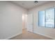 This bedroom features neutral carpeting, a window with blinds, and an open doorway at 15853 N 74Th Ave, Peoria, AZ 85382