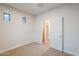 This bedroom features neutral carpeting and two small windows at 15853 N 74Th Ave, Peoria, AZ 85382