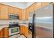 Kitchen features stainless steel appliances and light wood cabinets at 15853 N 74Th Ave, Peoria, AZ 85382