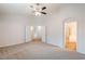 Large main bedroom with a ceiling fan and double door entry to other room at 15853 N 74Th Ave, Peoria, AZ 85382