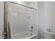 Bathroom interior featuring a tub with white tile walls and a neutral shower curtain at 1627 E Walter Dr, Casa Grande, AZ 85122