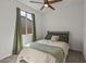 Bright bedroom with neutral tones, a ceiling fan, and a window providing natural light at 1627 E Walter Dr, Casa Grande, AZ 85122