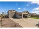 A view of the covered patio and large backyard with desert landscaping at 1627 E Walter Dr, Casa Grande, AZ 85122