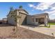 A neutral colored one-story home with a garage and covered patio at 1627 E Walter Dr, Casa Grande, AZ 85122