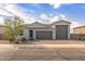 Charming single-story home with a three-car garage and a desert-landscaped front yard at 1627 E Walter Dr, Casa Grande, AZ 85122