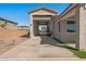 Exterior shot of the garage with open door, showcasing the extended driveway and home facade at 1627 E Walter Dr, Casa Grande, AZ 85122