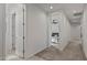 Hallway leading to rooms with neutral colored carpet and natural light coming through windows at 1627 E Walter Dr, Casa Grande, AZ 85122