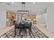 Open-concept kitchen with stainless steel appliances and a dining table with modern lighting at 1627 E Walter Dr, Casa Grande, AZ 85122