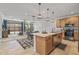 Open-concept kitchen with island, pendant lighting, view of dining area and living room at 1627 E Walter Dr, Casa Grande, AZ 85122