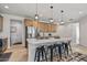 Kitchen island with pendant lights, seating, sink, and stainless steel refrigerator at 1627 E Walter Dr, Casa Grande, AZ 85122