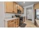 Well-lit kitchen with light wood cabinets, stainless steel appliances, and light countertops at 1627 E Walter Dr, Casa Grande, AZ 85122