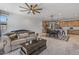 Inviting living room featuring a comfortable couch, ceiling fan, and an open view to the kitchen at 1627 E Walter Dr, Casa Grande, AZ 85122