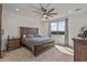 Comfortable main bedroom features a ceiling fan and large window, providing natural light and a relaxing atmosphere at 1627 E Walter Dr, Casa Grande, AZ 85122