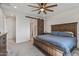 Spacious main bedroom with a wooden accent bed frame and a sliding barn door leading to the bathroom at 1627 E Walter Dr, Casa Grande, AZ 85122