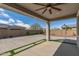 A covered patio features a ceiling fan and artificial grass accents in the concrete at 1627 E Walter Dr, Casa Grande, AZ 85122