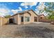 Backyard featuring gravel landscaping, fenced perimeter and covered patio at 17125 W Saguaro Ln, Surprise, AZ 85388