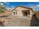 Backyard featuring a built-in brick fire pit at 17125 W Saguaro Ln, Surprise, AZ 85388