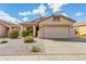 Inviting single-story home featuring low maintenance landscaping, tile roof, and an attached garage at 17125 W Saguaro Ln, Surprise, AZ 85388