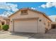 Well-maintained single-story home features a tile roof, two-car garage and gravel landscaping at 17125 W Saguaro Ln, Surprise, AZ 85388