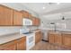 Traditional kitchen featuring wood cabinets, stainless steel appliances, and an open view to the living area at 17125 W Saguaro Ln, Surprise, AZ 85388