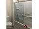 Bathroom featuring white subway tile, glass shower door and chrome fixtures at 1717 W Pollack St, Phoenix, AZ 85041