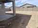 View of concrete backyard patio area and block fence with surrounding houses at 17216 W Sunward Dr, Goodyear, AZ 85338