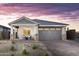 Charming home with a gray color scheme, desert landscaping, and brick driveway at 17216 W Sunward Dr, Goodyear, AZ 85338