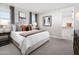 Serene main bedroom with large windows, plush bedding, and a walk-in closet for ample storage at 17216 W Sunward Dr, Goodyear, AZ 85338