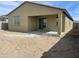 The exterior of a home showcases a covered patio area, and a large dirt backyard offering a blank canvas at 17296 W Desert Sage Dr, Goodyear, AZ 85338