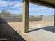 Backyard view from the covered patio with block wall, landscaping potential, and neighborhood homes beyond at 17296 W Desert Sage Dr, Goodyear, AZ 85338