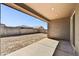 Under-construction backyard with a covered patio, block wall and potential for landscaping at 17296 W Desert Sage Dr, Goodyear, AZ 85338