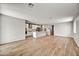 Expansive open-concept living area with wood-look floors connects the kitchen and other living spaces at 17296 W Desert Sage Dr, Goodyear, AZ 85338