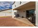 Relaxing covered patio with sliding glass door entrance to the home and outdoor cooking area at 18316 N Soft Wind Dr, Maricopa, AZ 85138