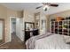 Bedroom with a vanity, closet, bed with a mauve throw, and decorative shelves at 18316 N Soft Wind Dr, Maricopa, AZ 85138