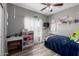 Bedroom featuring a large window, ample lighting, and a workstation at 18316 N Soft Wind Dr, Maricopa, AZ 85138