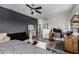 Bedroom featuring a workspace, ceiling fan, and gray accent wall at 18316 N Soft Wind Dr, Maricopa, AZ 85138