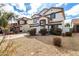 Two-story home with a two-car garage, neutral paint, and desert landscaping at 18316 N Soft Wind Dr, Maricopa, AZ 85138