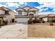 Two-story home featuring a two-car garage, neutral paint, and desert landscaping at 18316 N Soft Wind Dr, Maricopa, AZ 85138