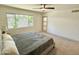 Bedroom with large window, neutral carpet, a ceiling fan, and a comfortable queen bed at 1901 E Missouri Ave # 220, Phoenix, AZ 85016