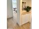 Hallway with white cabinets and decorative art creating a welcoming transition space at 1901 E Missouri Ave # 220, Phoenix, AZ 85016
