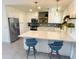Bright kitchen with stainless steel appliances, white cabinetry, and center island seating at 1901 E Missouri Ave # 220, Phoenix, AZ 85016