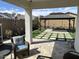 Covered patio area overlooking a landscaped backyard with a gazebo and artificial turf at 19864 W San Juan Ave, Litchfield Park, AZ 85340