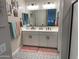 Bathroom features double sinks, framed mirror, and stylish tile flooring at 19864 W San Juan Ave, Litchfield Park, AZ 85340